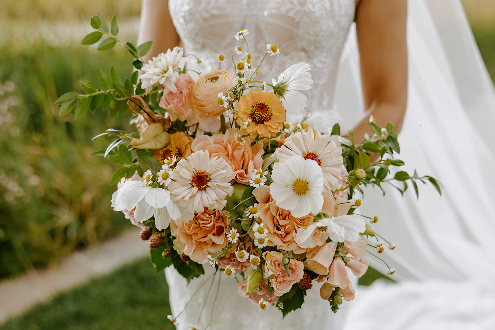 Bride holding peach bridal bouquet