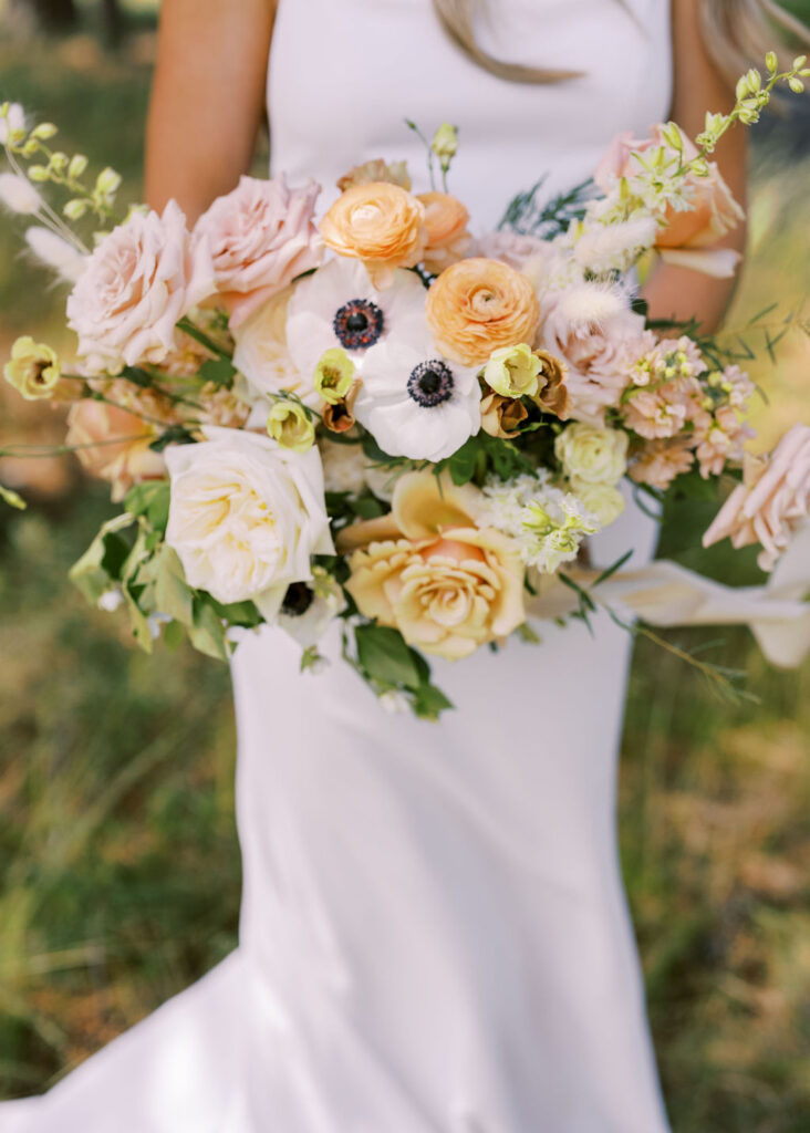 Bride holding pastel wedding bouquet